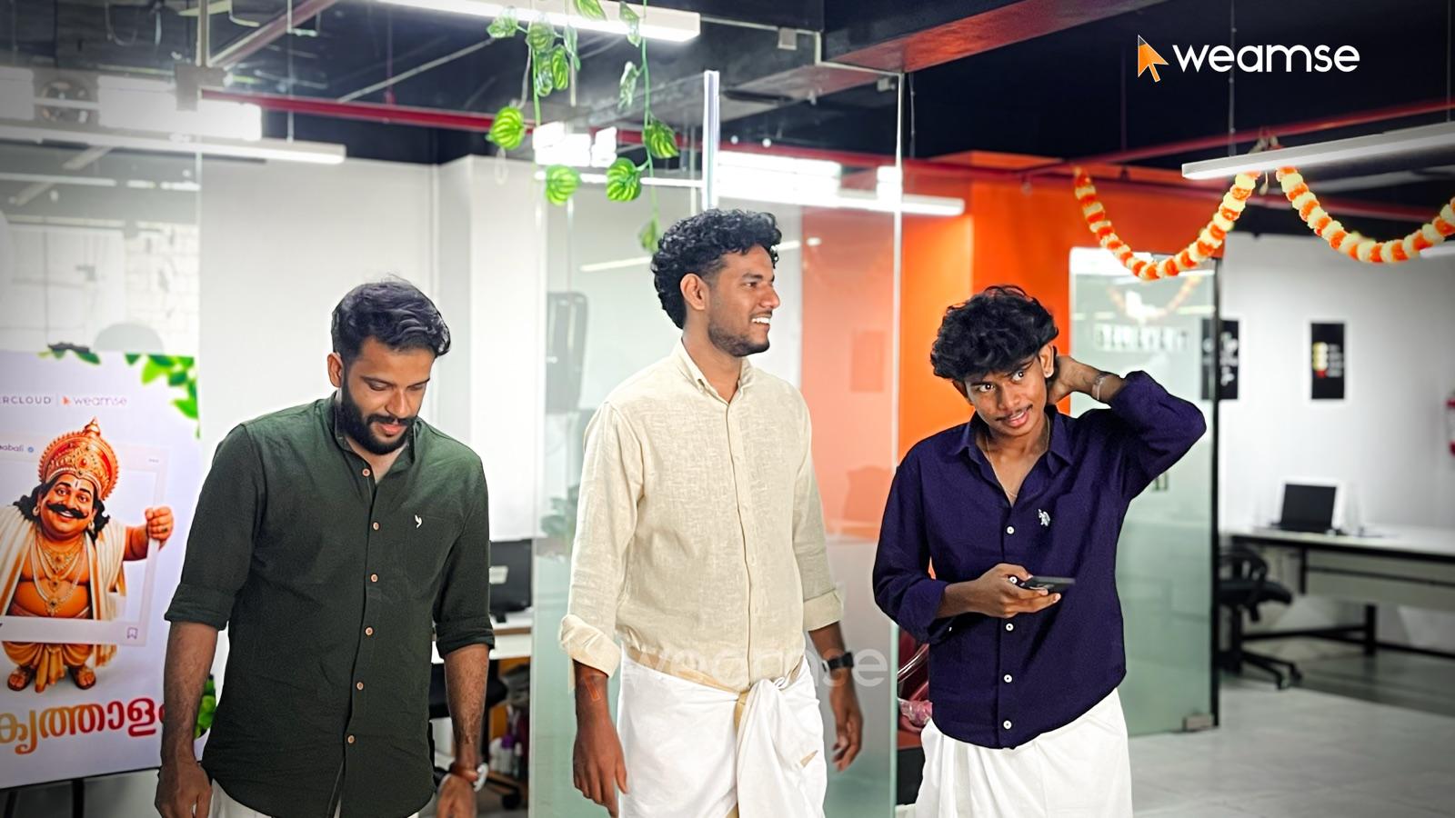 Team members in traditional dress celebrating Onam at the office