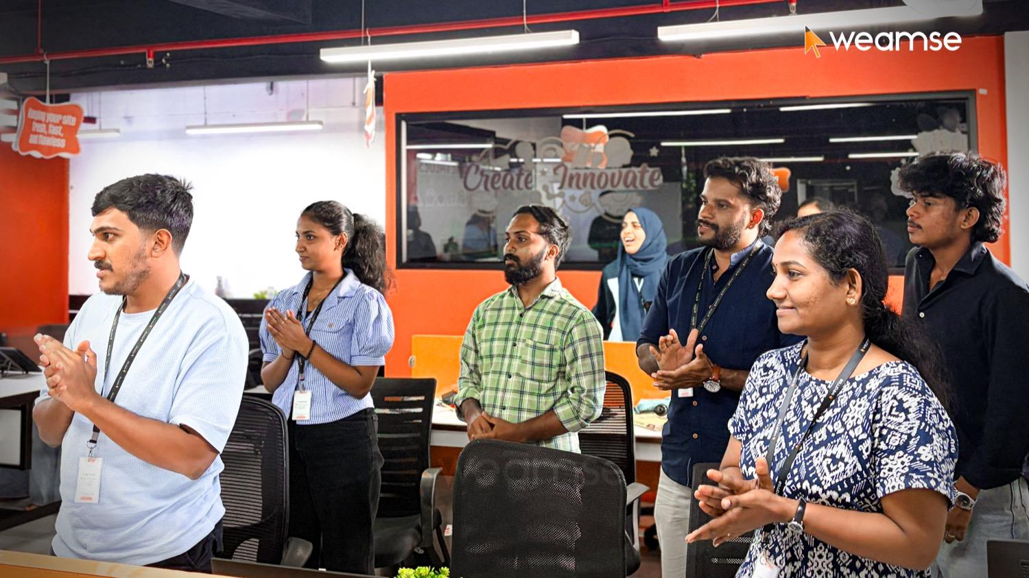 The WEAMSE team applauding at an office gathering