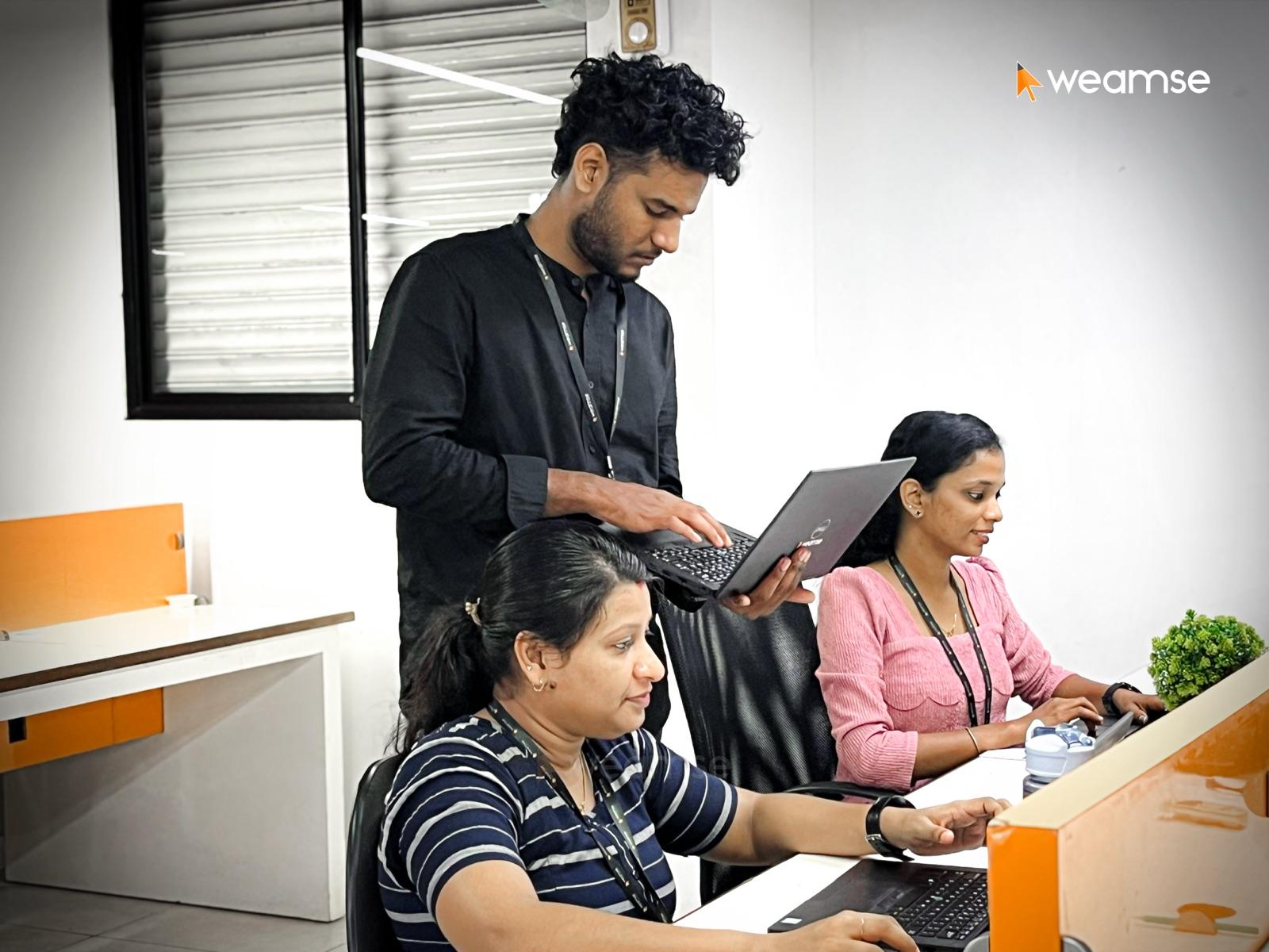 WEAMSE developers reviewing work together at the office
